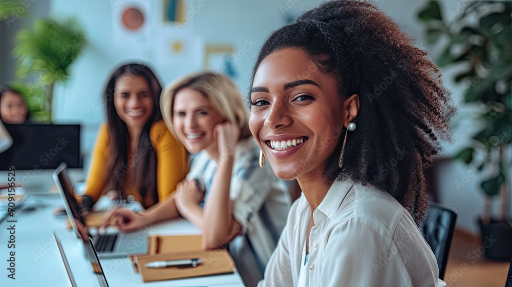 Happy multiethnic smiling business women working together in office Happy multiethnic smiling business women working together in office