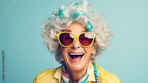 Portrait of a sweet smiling laughing grandmother with gray hair and glasses.