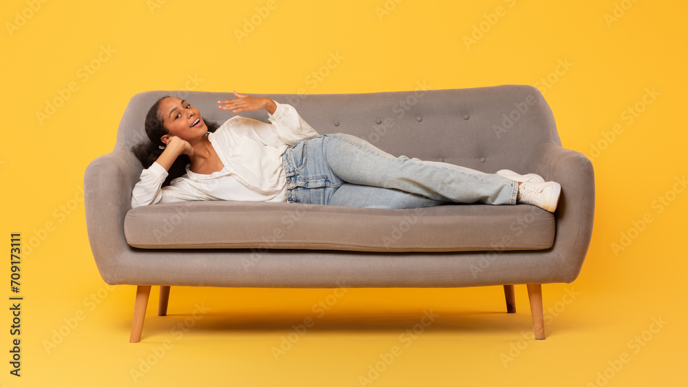black teen girl in casual lying on couch in studio
