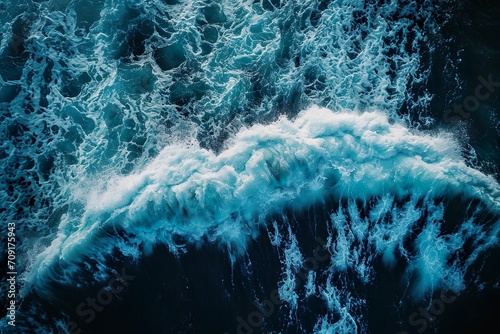 Spectacular aerial top view background photo of ocean sea water white wave splashing in the deep sea. © Kasorn