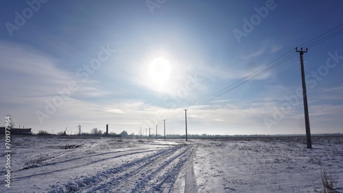 Sun in the sky, field covered with snow, winter