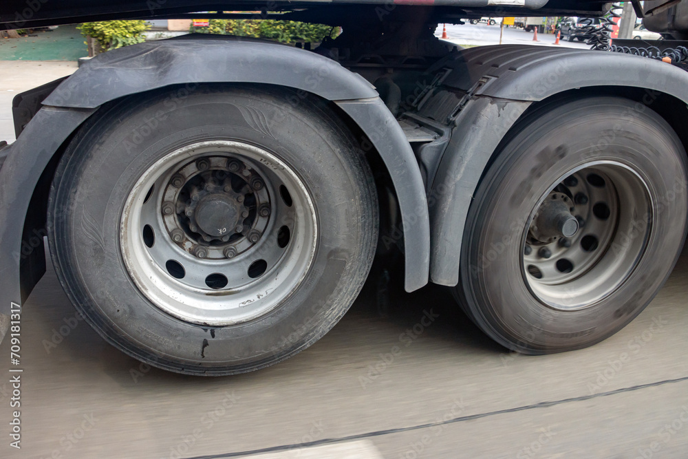 View of the rear wheels of a truck while driving with the rear axle raised View of the rear wheels of a truck while driving with the rear axle raised