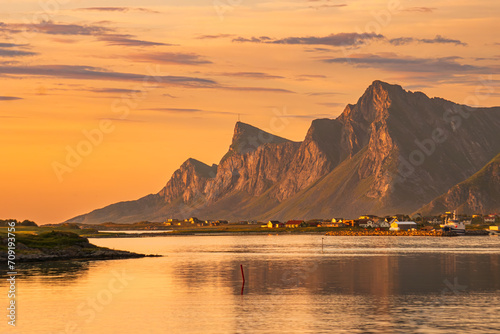 Evening view over northern Lofoten, Norway. Mountains, sea, reflections, cloudscape. Spectacular scenery. The town of Ramberg in the distance. photo