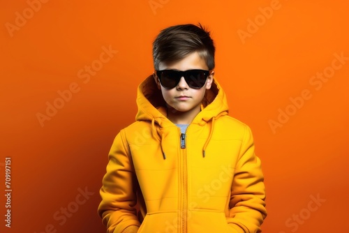 Young kid fashion model on a single colored background.