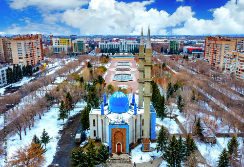 drone flight over city administration building akimat and central square of Ust Kamenogorsk, winter cloudy day. photo
