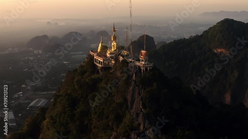 Aerial orbit shot of Tiger cave temple Wat Tham Suea Krabi Thailand during sunrise photo