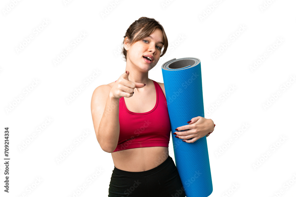 Young sport girl going to yoga classes while holding a mat over isolated chroma key background pointing front with happy expression Young sport girl going to yoga classes while holding a mat over isolated chroma key background pointing front with happy expression