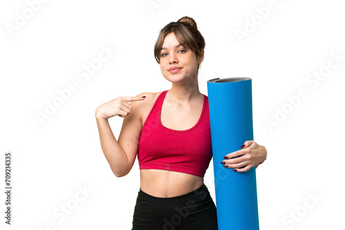 Young sport girl going to yoga classes while holding a mat over isolated chroma key background giving a thumbs up gesture