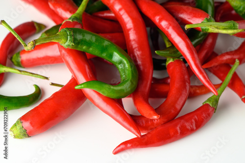 red and green peppers scattered on a white table 8