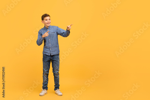 Nice Offer. Cheerful Teen Boy Pointing At Copy Space With Two Hands