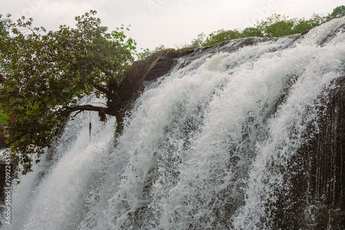 Beautiful close up of a waterfall. Nature background with detailed texture. Fresh and clean river water flowing down a mountain environment. Thirparappu waterfalls, Kanyakumari, Tamil Nadu, India.