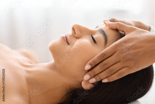 Tranquil beauty with a soothing head rub in a wellness center