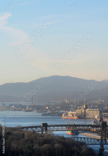 The Ironworkers Memorial Second Narrows Crossing connecting Vancouver to the North Shore in the Burrard Inlet as seen from Capitol Hill during a winter season in Burnaby, British Columbia, Canada photo