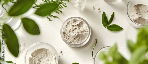 Laboratory research on natural cosmetics, using lab glassware and petri dishes, testing efficiency in vitro with clay powder and green leaves.