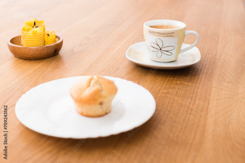 Fresh muffin with coffee for breakfast. Candel on the desk. Fresh muffin with coffee for breakfast. Candel on the desk.