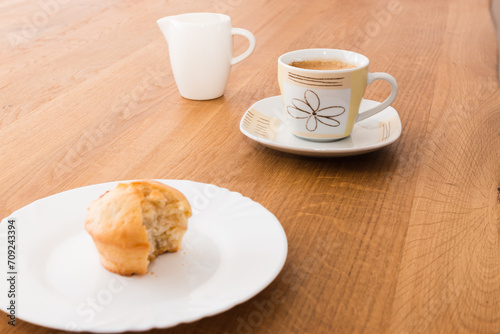 Bite-sized muffin with coffee and milk for breakfast