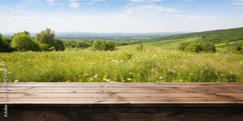 Wooden table with a blurry meadow backdrop.