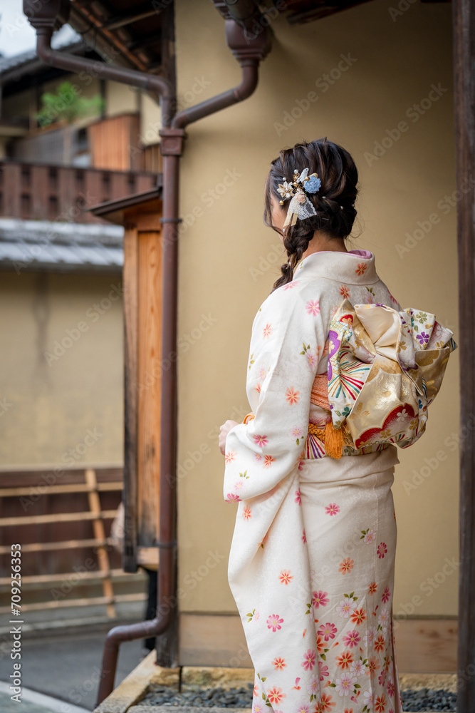 Japanese Female Kimono Portrait back view photography. Kyoto, Japan. Japanese traditional buildings background.