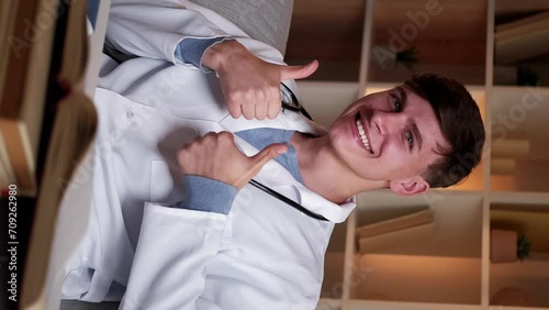 Wallpaper Mural Vertical video. Great result. Approval hand sign. Medical student. Doctor education. Happy man in white uniform with like gesture thumbs up sitting at desk books at clinic. Torontodigital.ca