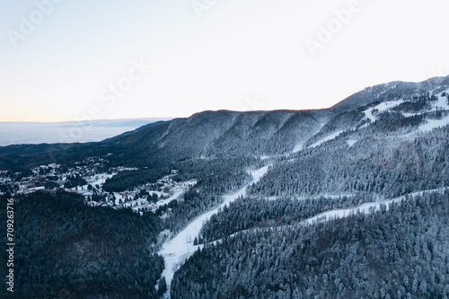 Winter ski resort, ski slope, lift cabins and gondola of aerial view 