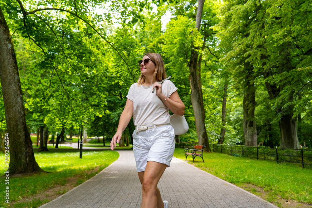 Healthy lifestyle - woman walking in city park Healthy lifestyle - woman walking in city park