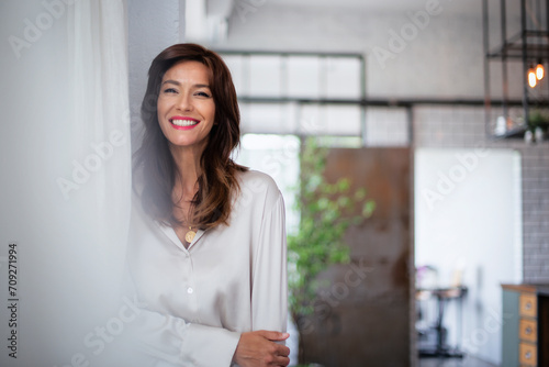 Free Download Close-up of a cheerful smiling brunette haired woman standing at wall - GFXLoad