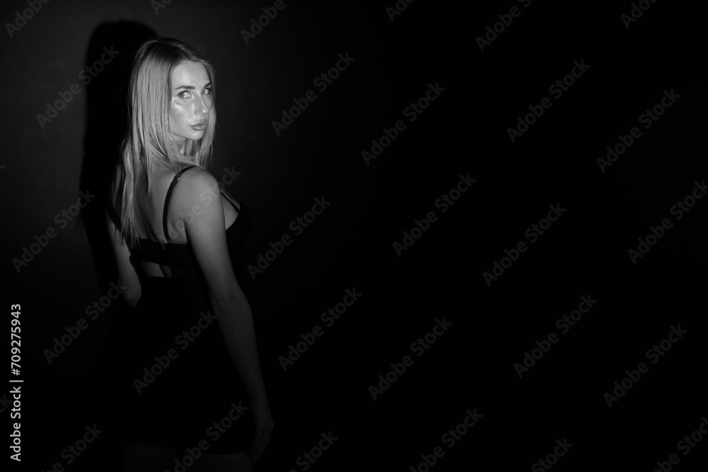 Black and white low key portrait of pretty woman in short dress Black and white low key portrait of pretty woman in short dress