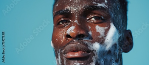 Grooming and skincare for confident African man after cleansing. photo