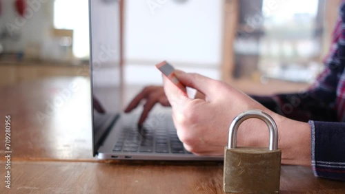 Woman typing on computer keyboard. Computer padlock card payment. Security and protection of secure payments, data security, security, and decentralization of transactions and data. photo