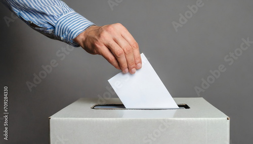 close up of Voter hand Putting Ballot Into Voting box