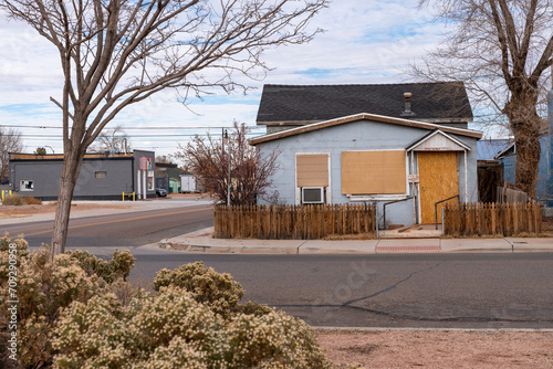 Sad, empty abandoned and boarded up home in Winslow Arizona photo