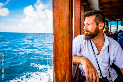 handsome caucasian man travelling on a local ferry © Melinda Nagy