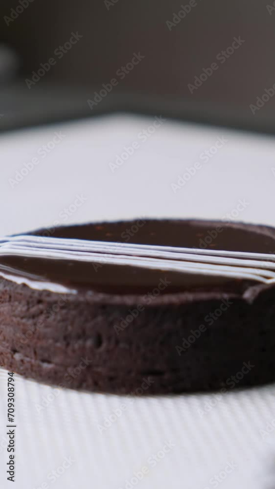 the process of making a delicious chocolate tart with cherry jam. Chocolate pours on the tart. Pastry cone with cherry filling. The pastry chef makes a dessert the process of making a delicious chocolate tart with cherry jam. Chocolate pours on the tart. Pastry cone with cherry filling. The pastry chef makes a dessert