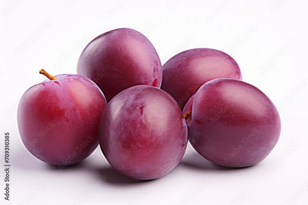 Obraz premium purple plum isolated on a white background. violet fruit, a bunch of berries.