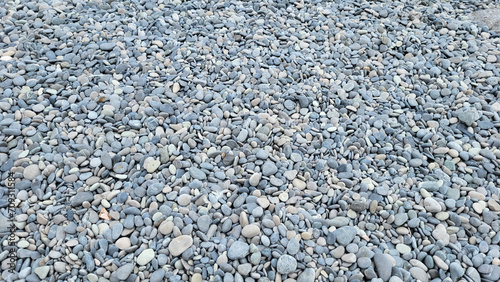 Background of grey sea pebbles on a summer day.