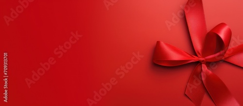 Red ribbon isolated on a red background for world aids day, World cancer design concept. Generate AI photo