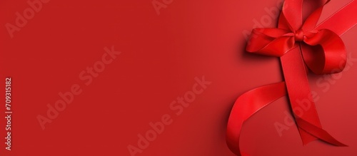 Red ribbon isolated on a red background for world aids day, World cancer design concept. Generate AI photo