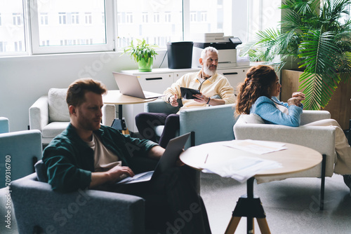 Multiracial people working in office lounge
