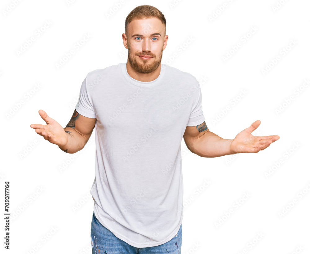 Young irish man wearing casual clothes clueless and confused expression with arms and hands raised. doubt concept.