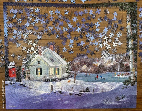 фотографія A puzzle on a wooden table halfway completed