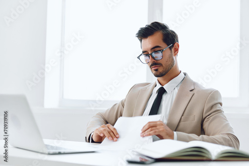 Planning paper workplace holding document laptop businessman attractive office happy company suit