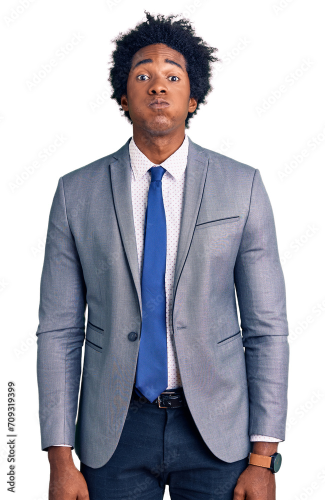 Handsome african american man with afro hair wearing business jacket puffing cheeks with funny face. mouth inflated with air, crazy expression. Handsome african american man with afro hair wearing business jacket puffing cheeks with funny face. mouth inflated with air, crazy expression.
