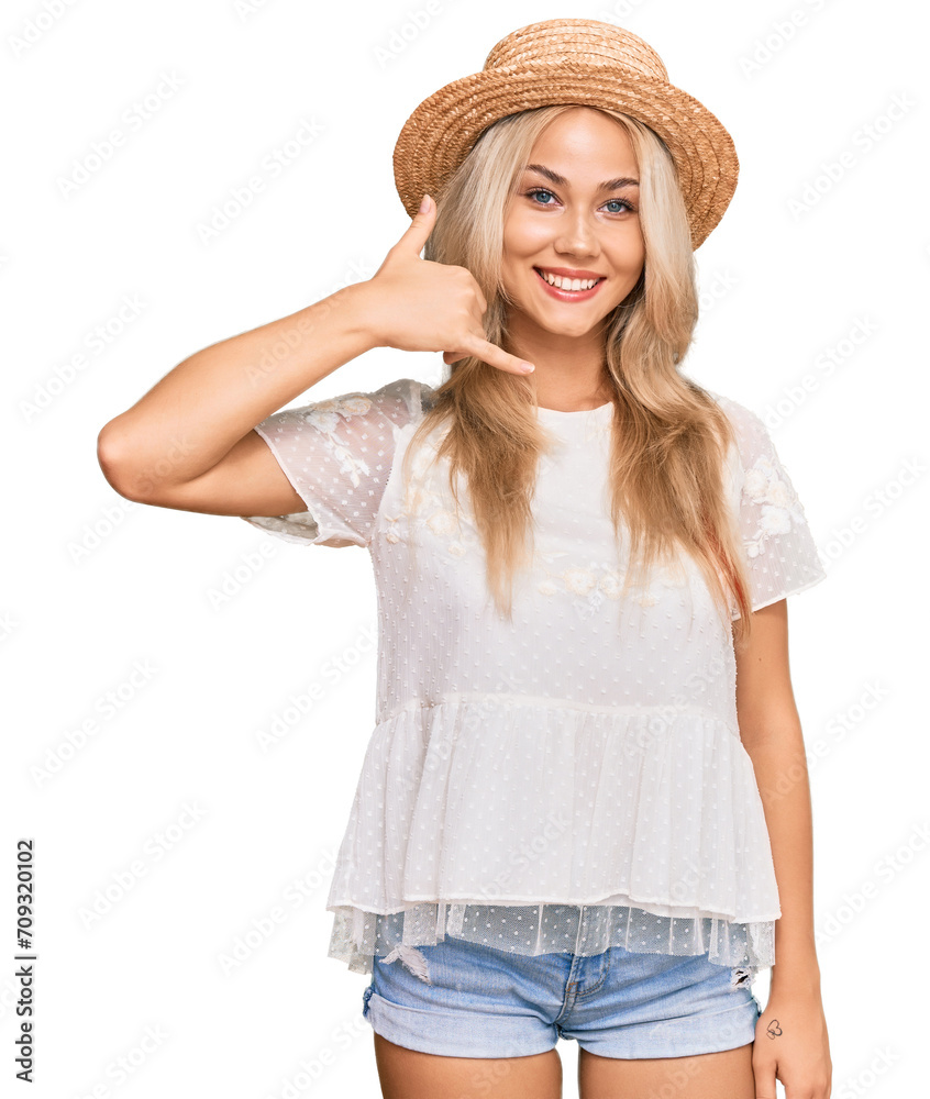 Young blonde girl wearing summer hat smiling doing phone gesture with hand and fingers like talking on the telephone. communicating concepts. Young blonde girl wearing summer hat smiling doing phone gesture with hand and fingers like talking on the telephone. communicating concepts.
