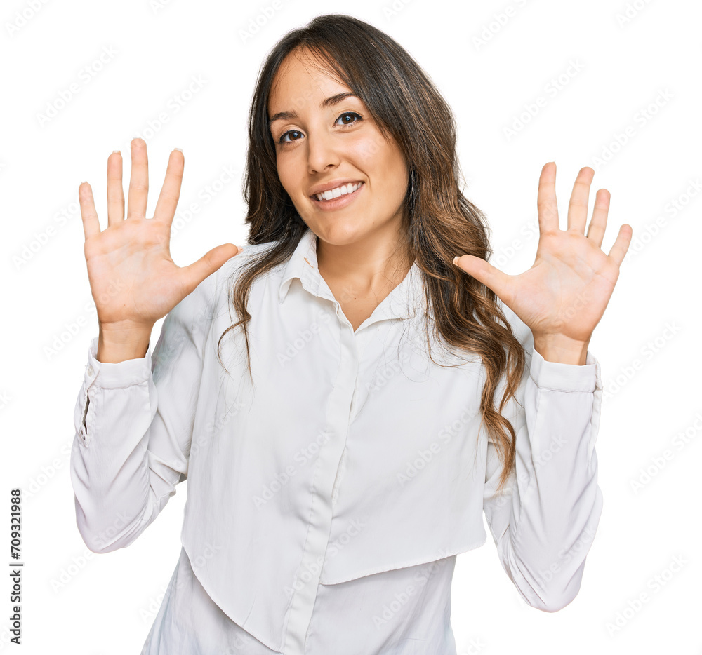 Young brunette woman wearing casual clothes showing and pointing up with fingers number ten while smiling confident and happy. Young brunette woman wearing casual clothes showing and pointing up with fingers number ten while smiling confident and happy.