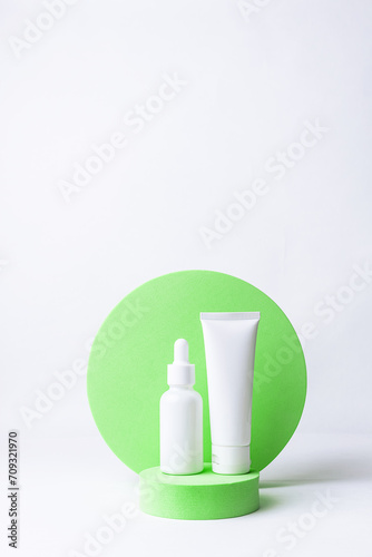Wallpaper Mural Minimalism style composition with white unbranded cosmetic tube and bottle with dropper on bright green cosmetic podium on white background. Cosmetic sale and promo banner, copy space for your design. Torontodigital.ca