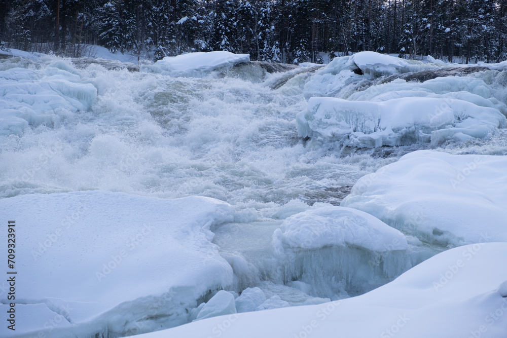 Waterfall Storforsen, river in Sweden in the snow Waterfall Storforsen, river in Sweden in the snow