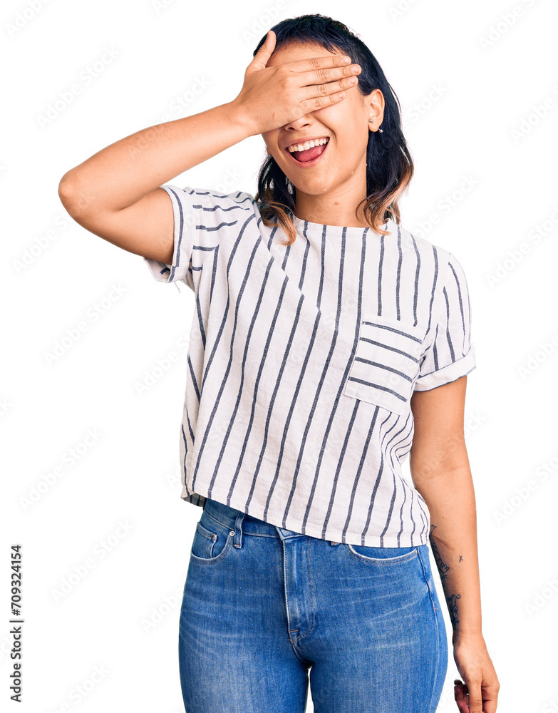 Young woman wearing casual clothes smiling and laughing with hand on face covering eyes for surprise. blind concept. Young woman wearing casual clothes smiling and laughing with hand on face covering eyes for surprise. blind concept.