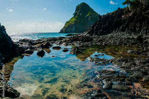 The best-known rock formation in the Fernando de Noronha Archipelago called Morro Dois Irmãos and the green sea of the Atlantic Ocean
