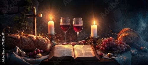 Symbolic Last Supper with wine, bread, suffering cross, candles, and Bible. photo