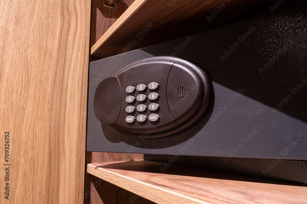 Safe with combination lock. Money box. Black safebox closeup. Metal